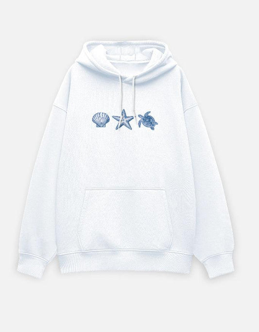 White oversized hoodie with blue sea shell, starfish, and turtle graphics on front by Adhrit Studios